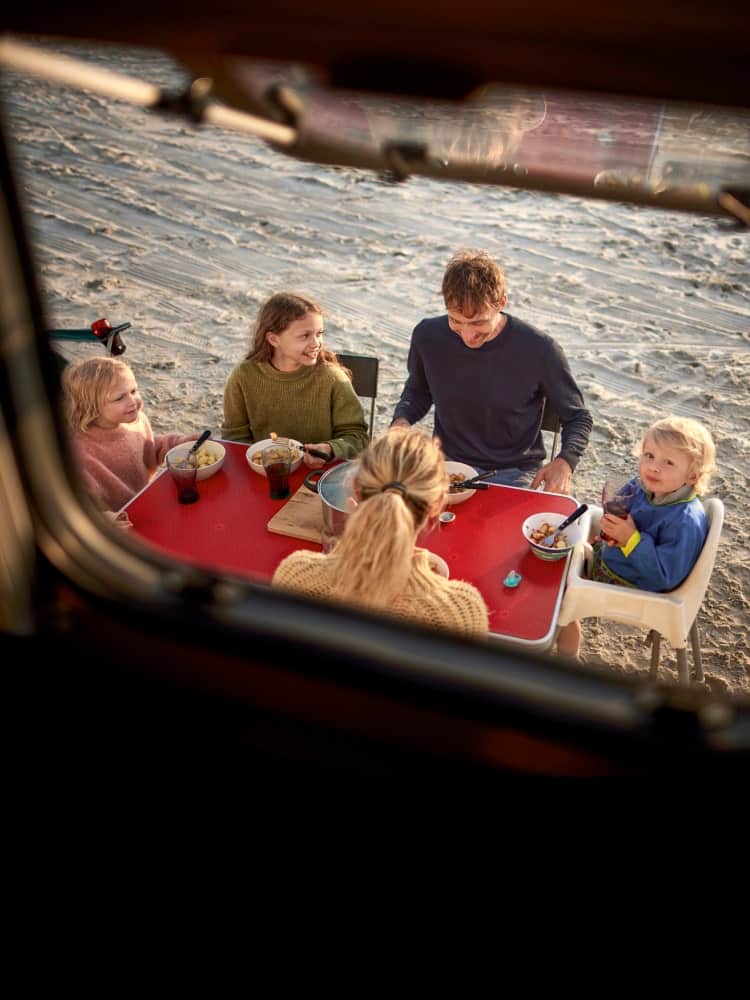 family eating a meal outstide the RV