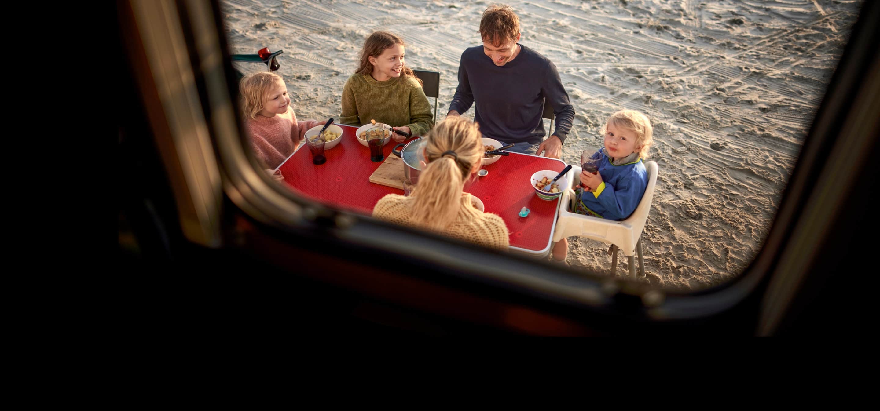 family eating a meal outstide the RV