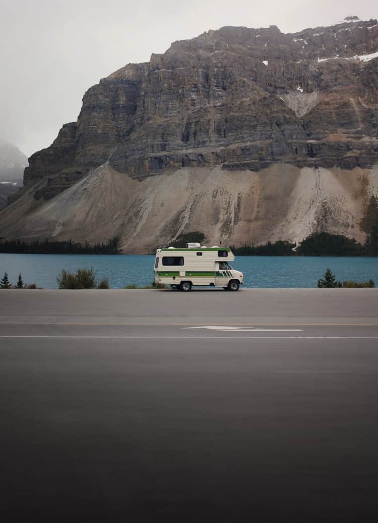 rv driving on lakeside road