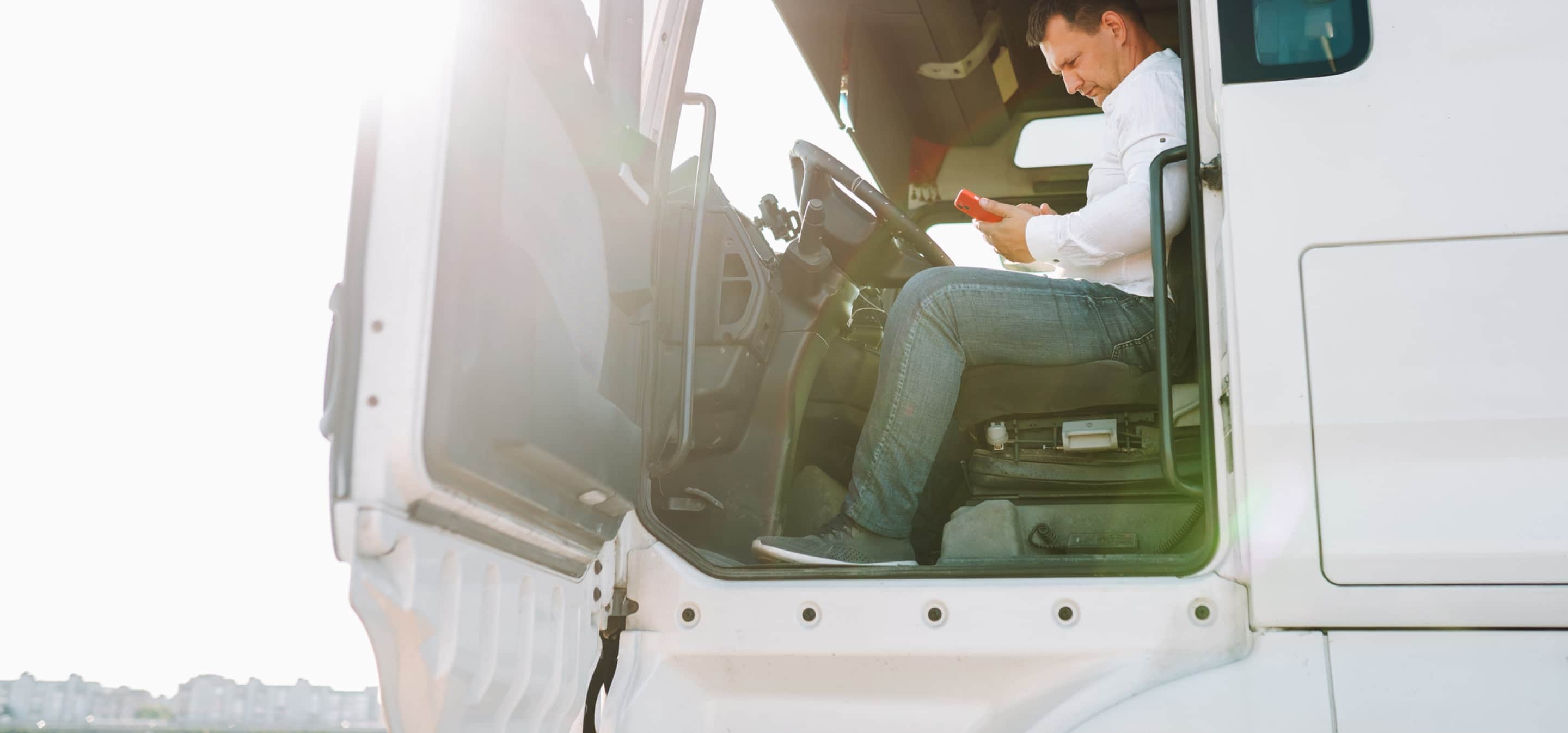 trucker using phone in truck