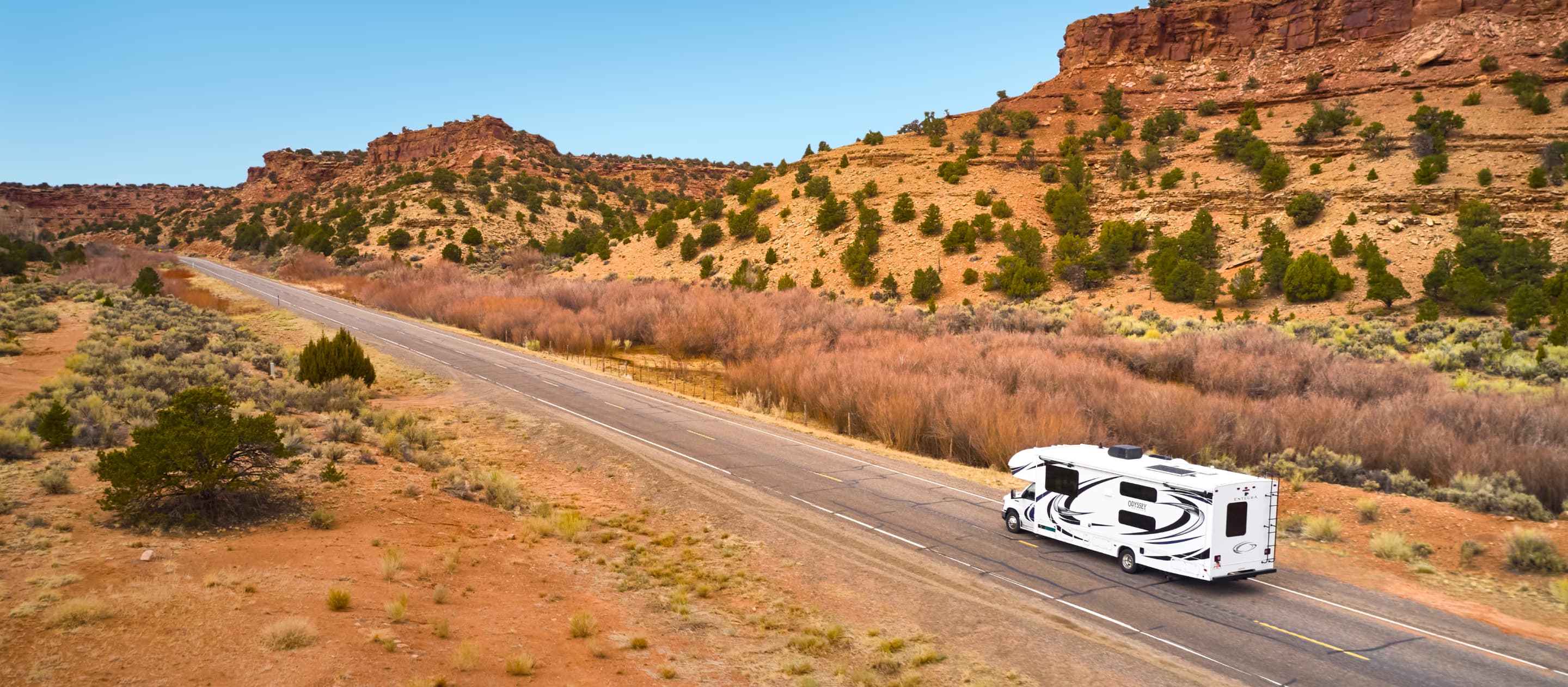 rv driving through desert landscape